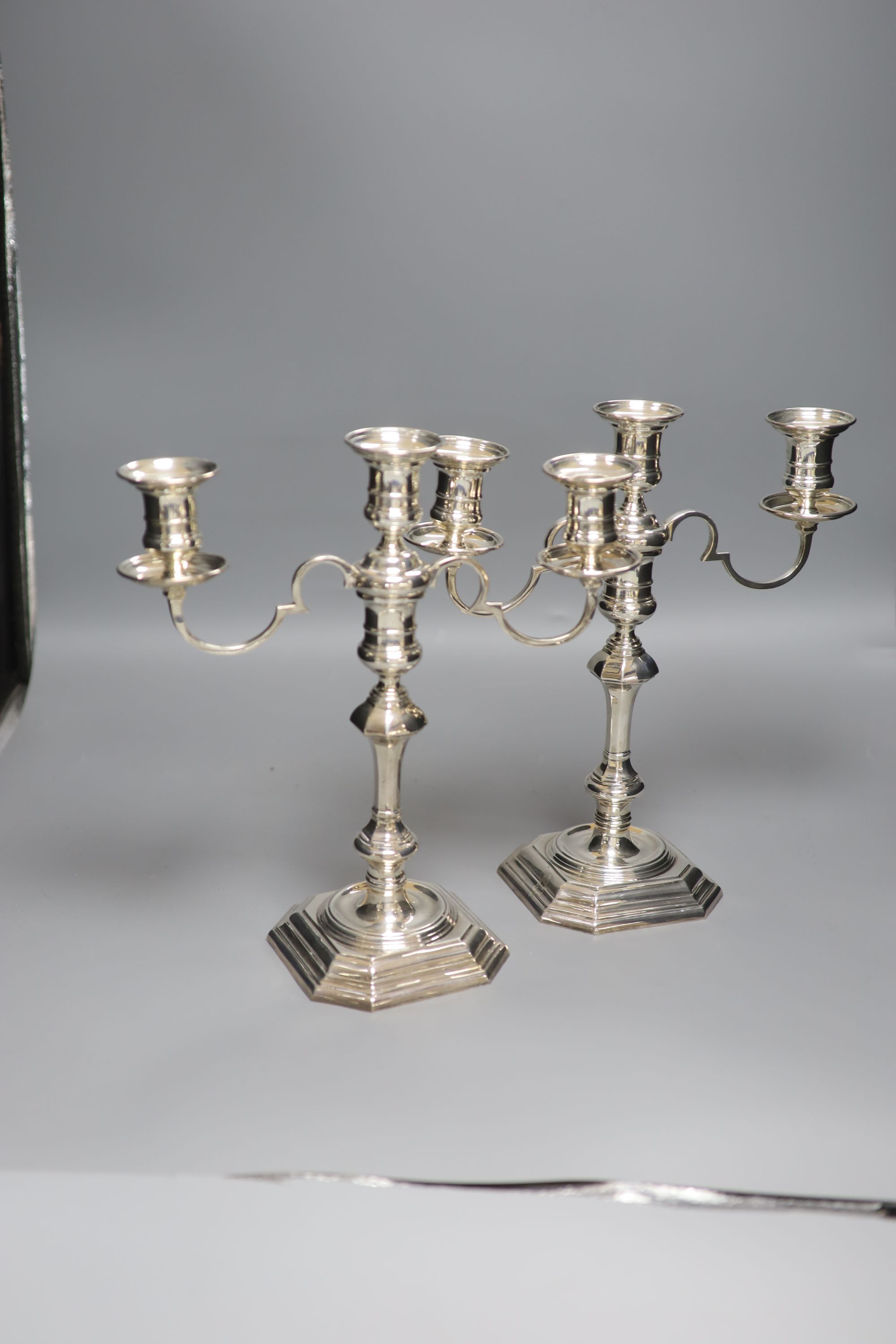 A pair of George I style silver two-branch three-light candelabra, Birmingham 1967, Makers: Elkington & Co,